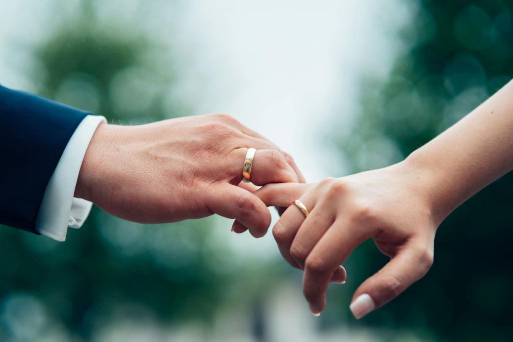 Man wearing a ring size 10 picking a female finger. Guide on how to choose the perfect ring size 10