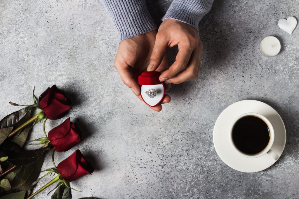 Couple choosing an engagement ring together at a jewelry store.